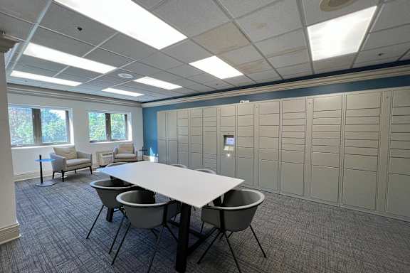 A conference room with a long table and chairs.