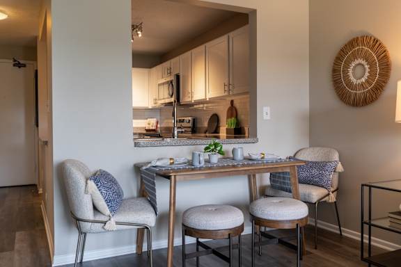 A dining area with a table and chairs.