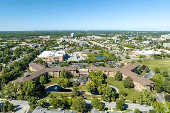 A large building complex with a green lawn in front.