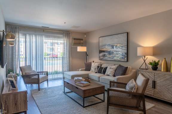 A living room with a couch, chair, and coffee table.
