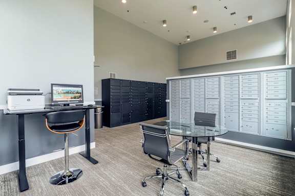 A modern office with a desk, chair, and computer.