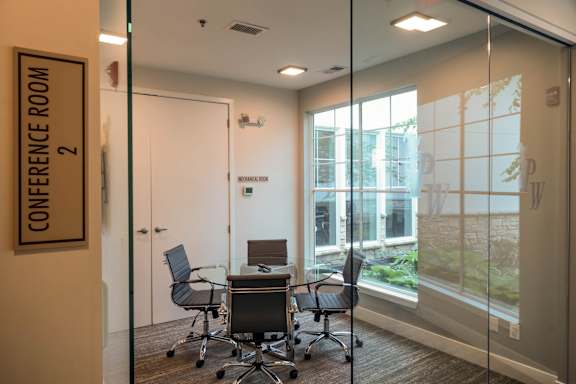 A conference room with a glass wall and a sign that says "Conference Room 2".