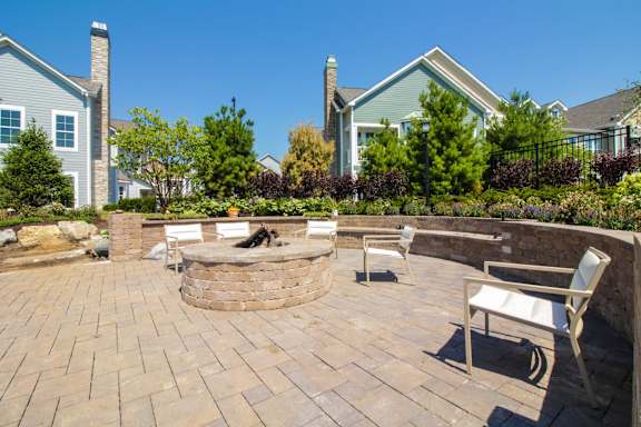 A backyard with a fire pit and seating area.