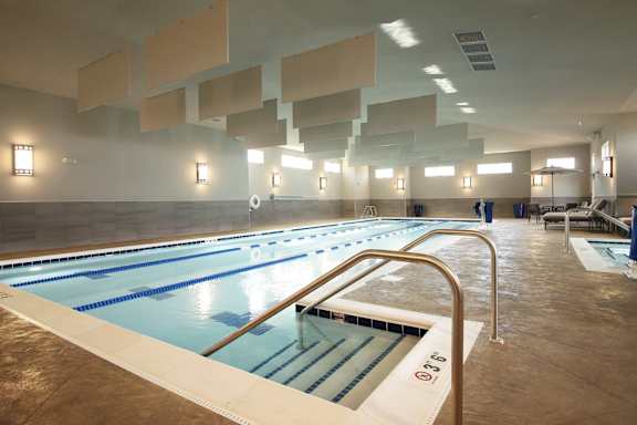 A large indoor swimming pool with lanes marked for swimming.