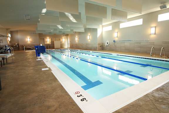 A large indoor swimming pool with lanes marked for swimming.