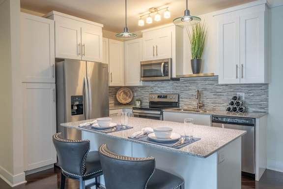 A kitchen with a table set for two.