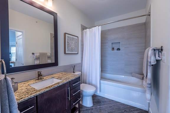 A bathroom with a sink, toilet, and bathtub.