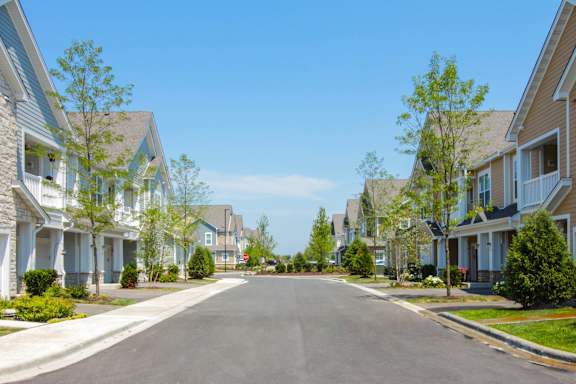 A street view of a residential area with houses on both sides.