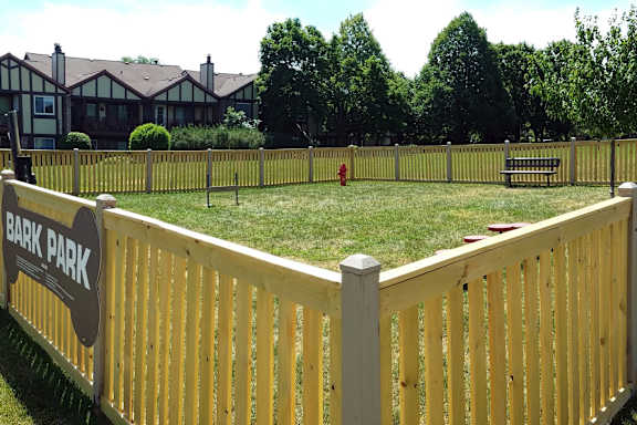 A fence with a sign that says Bark Park.