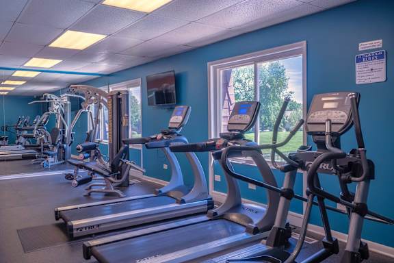 A gym with treadmills and exercise equipment.