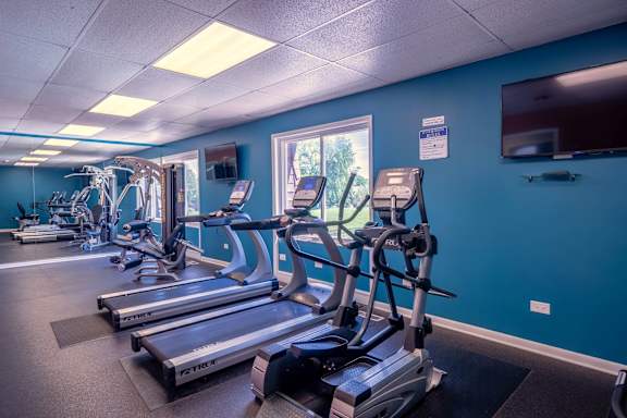 A gym with treadmills and exercise equipment.