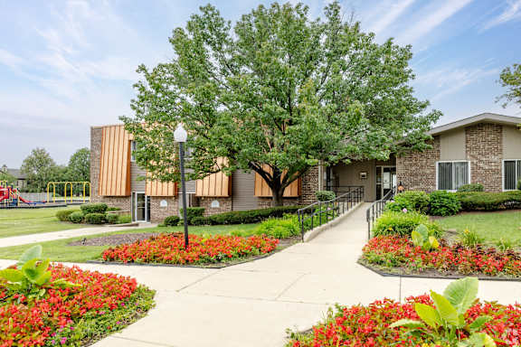 A building with a tree in front of it.