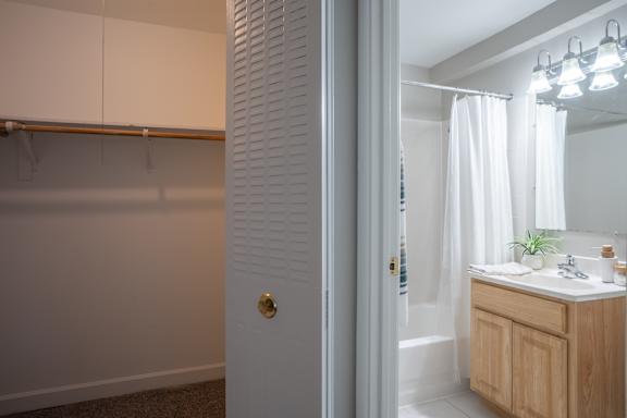 A bathroom with a white door and a white sink.