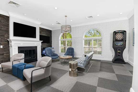 A living room with a fireplace and a dartboard.