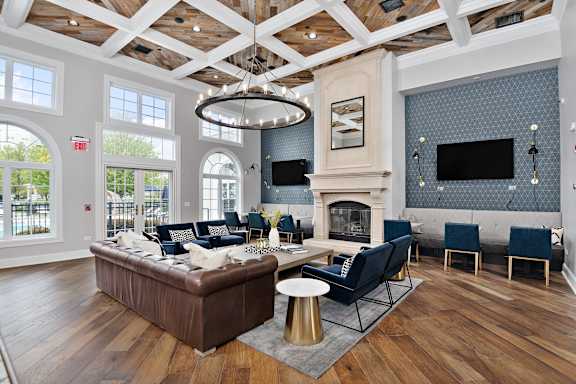 A living room with a fireplace and a blue couch.