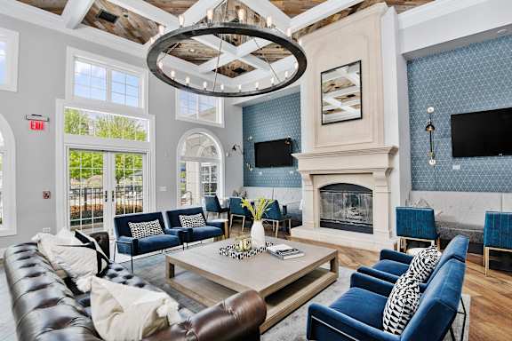 A living room with a fireplace and a large chandelier.