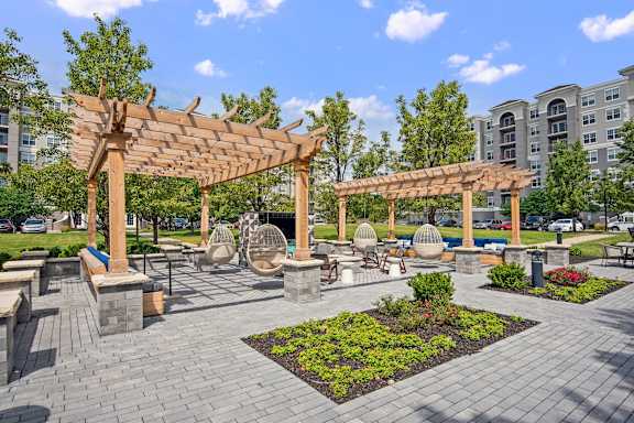 A park with a wooden pergola and benches.