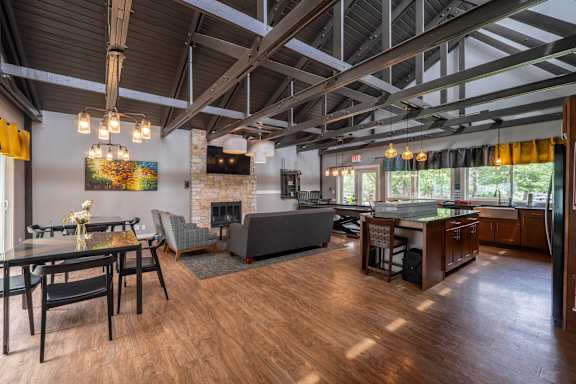 A modern open plan living and dining room with a fireplace.