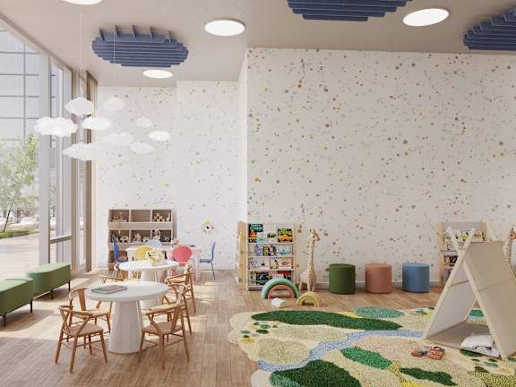 A room with a white table surrounded by chairs and a wall with a pattern of small objects.
