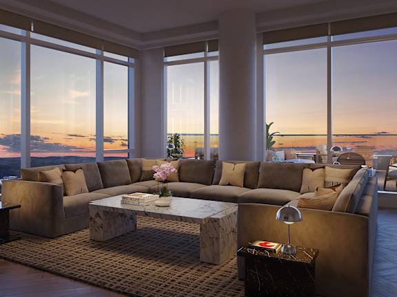 A living room with a large couch and a coffee table in front of a window.