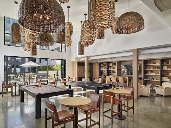 A room with a pool table and a bar.