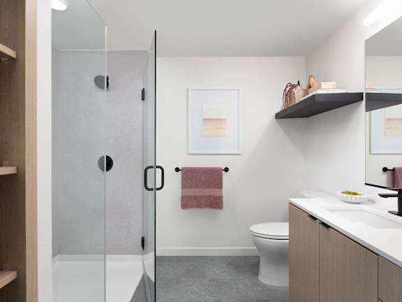 A bathroom with a toilet, sink, and shower.