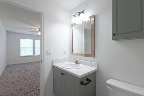 a bathroom with a sink and a mirror at Sterlington Apartments, Grovetown, GA