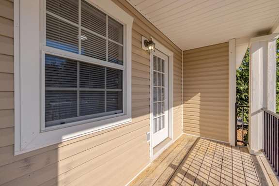 the screened porch of a home with a large window at Sterlington Apartments, Grovetown, Georgia