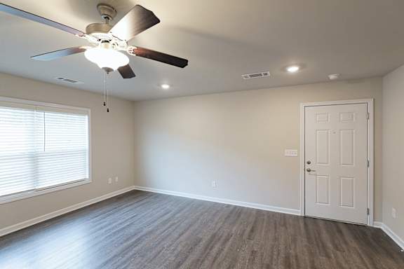 Living room with ceiling fan and light at The Vista Apartments &amp; Townhomes, South Carolina