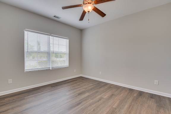 Bedroom with ceiling fan at The Vista Apartments &amp; Townhomes, South Carolina