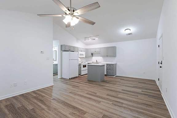 an empty living room and kitchen with a ceiling fan at Sterlington Apartments, Grovetown, GA