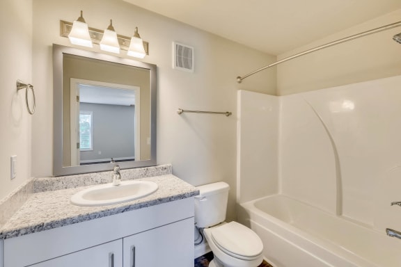 a bathroom with a sink toilet and shower and a mirror at MacArthur Park, Augusta, GA, 30909