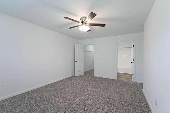 an empty living room with a ceiling fan at Sterlington Apartments, Grovetown