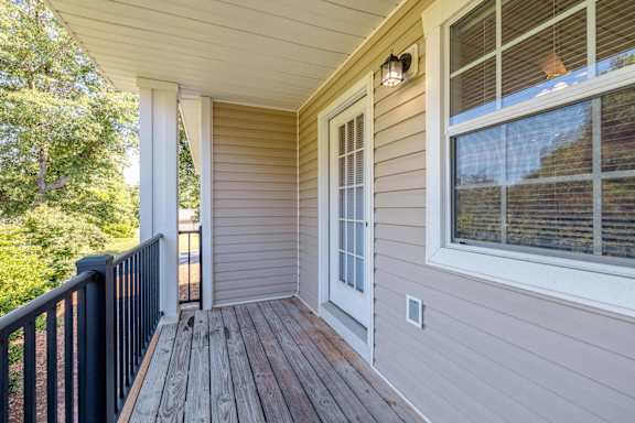 the deck of a home with a large window and a black railing at Sterlington Apartments, Georgia