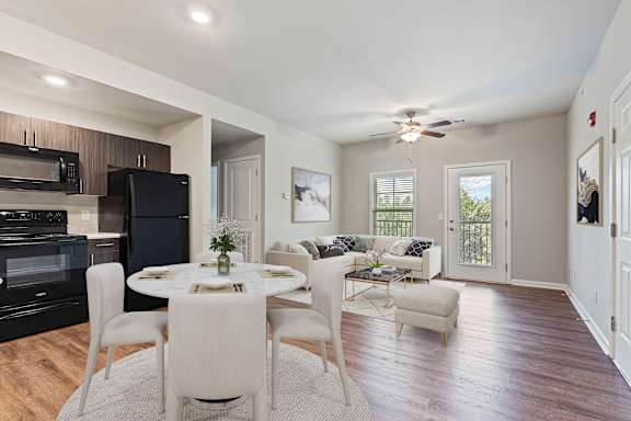 modern dining room with a black fridge at The Vista Apartments &amp; Townhomes, Warrenville, SC 29851