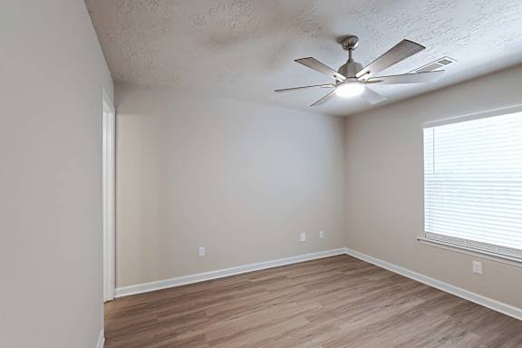 Bright well-lit room with ceiling fan at Sanctuary Apartments and Townhomes, Augusta Georgia