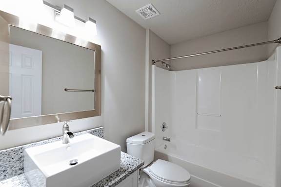 Open spacious bathroom with bathtub enclosure at Sanctuary Apartments and Townhomes, Augusta