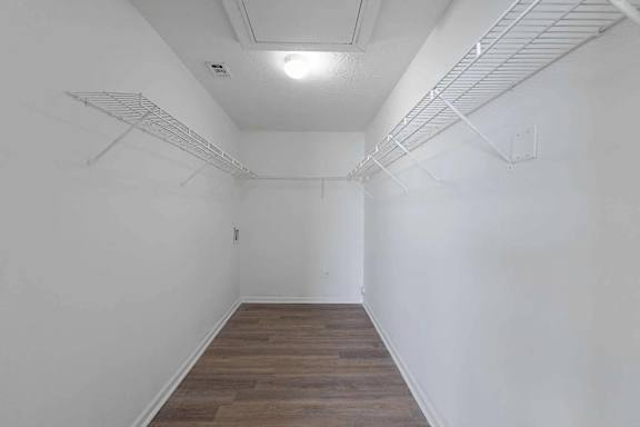 a white room with white walls and a wood floor at Sterlington Apartments, Grovetown, Georgia