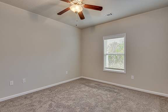 Carpeted bedroom with ceiling fan at Barrington Apartments, Greenwood, 29649