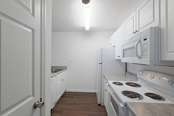 Well-lit cozy kitchen with cabinet design at Sanctuary Apartments and Townhomes, Augusta, GA