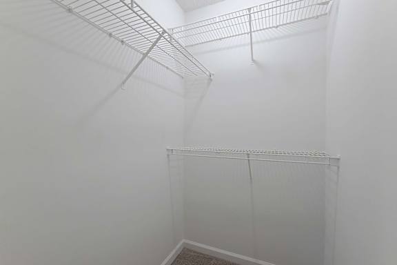 Elegant clean closet with metal shelves at Sanctuary Apartments and Townhomes, Augusta, GA
