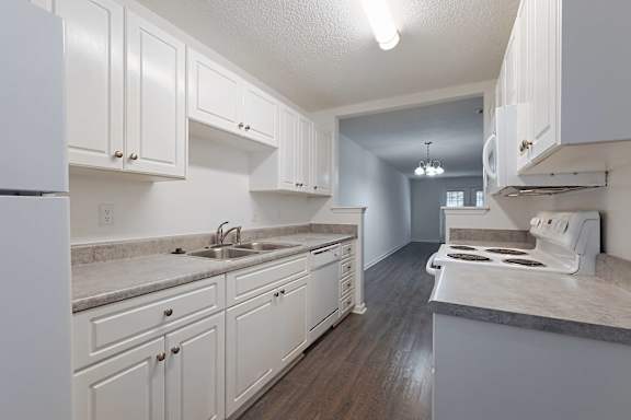 Calming neutral kitchen with granite counter at Sanctuary Apartments and Townhomes, Augusta, 30909