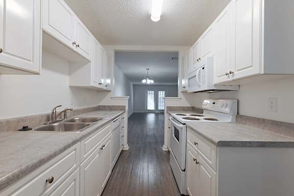 Illuminated spacious kitchen with granite counter at Sanctuary Apartments and Townhomes, Augusta Georgia