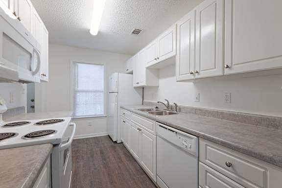 Smart compact kitchen with cabinet layout at Sanctuary Apartments and Townhomes, Augusta Georgia