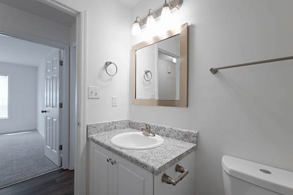 Chic organized bathroom with sink cabinet at Sanctuary Apartments and Townhomes, Augusta, GA