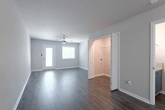 Large living room with multiple doors at Sanctuary Apartments and Townhomes, Augusta, 30909