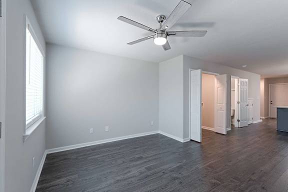 Large living room with fan and kitchen attached at Sanctuary Apartments and Townhomes, Augusta, 30909