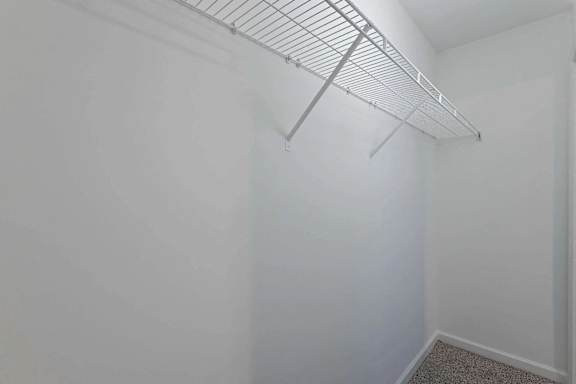 a closet in a white room with a rack on the wall at Sterlington Apartments, Grovetown, Georgia