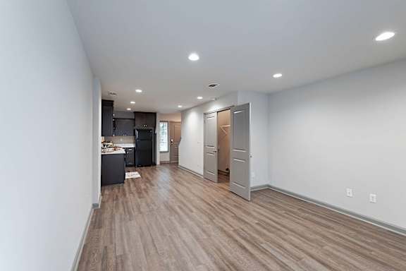 A room with wooden floors and white walls.