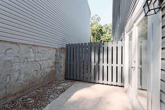 A concrete wall with numbers and a wooden fence.